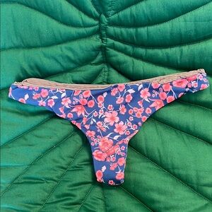 Acacia Swimwear cheeky bikini bottom. Color: Poppy. Blue with pink floral print